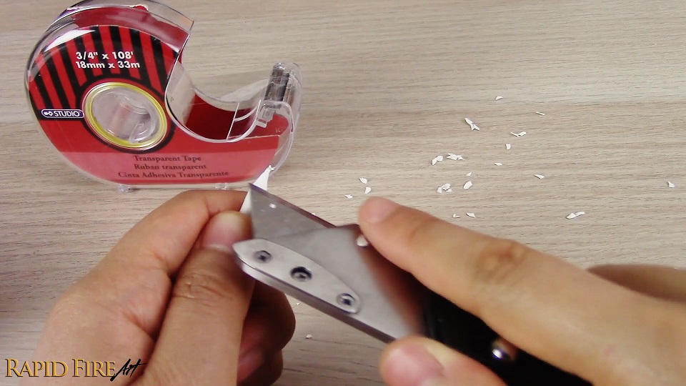 sharpening the end of a blending stump using a box cutter